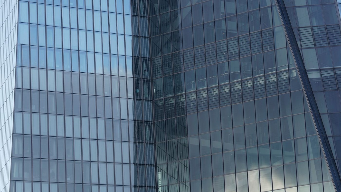 A curtain wall up close: factory-sealed modules seated into gasketed mullions, grid after grid.