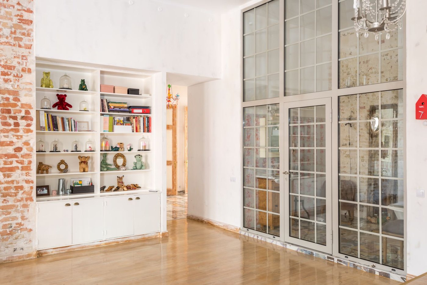 Steel-framed glass wall and door assembly: the framed family that screens and doors share.